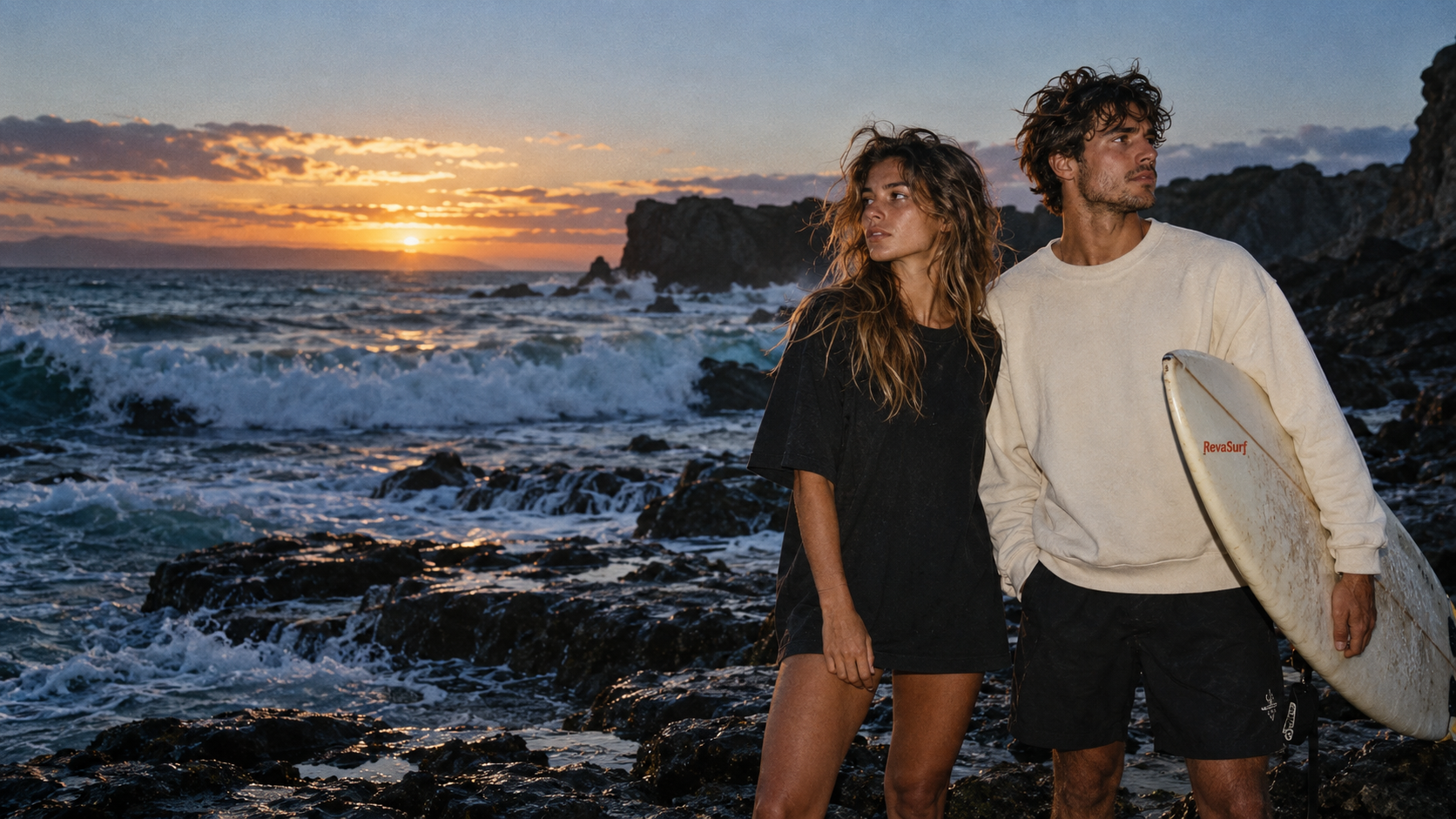 Two surfers at a rocky Pacific beach in the early morning light